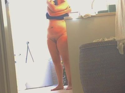 voyeur cam catches unaware MILF dressing