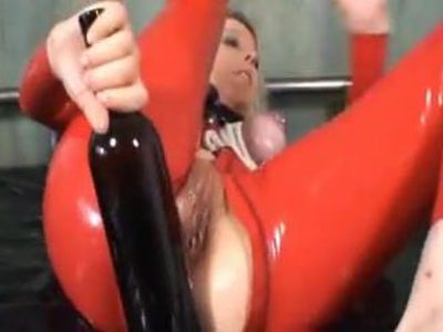 German milf use a bottle of wine as a dildo in red latex