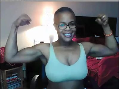 Pretty black MILF flexes her big muscles