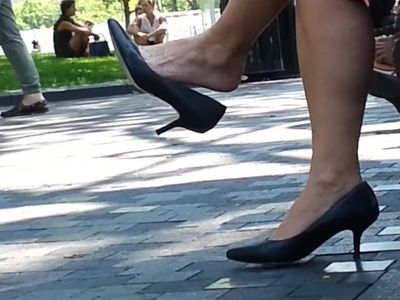 Sexy mature woman dangling her high heels